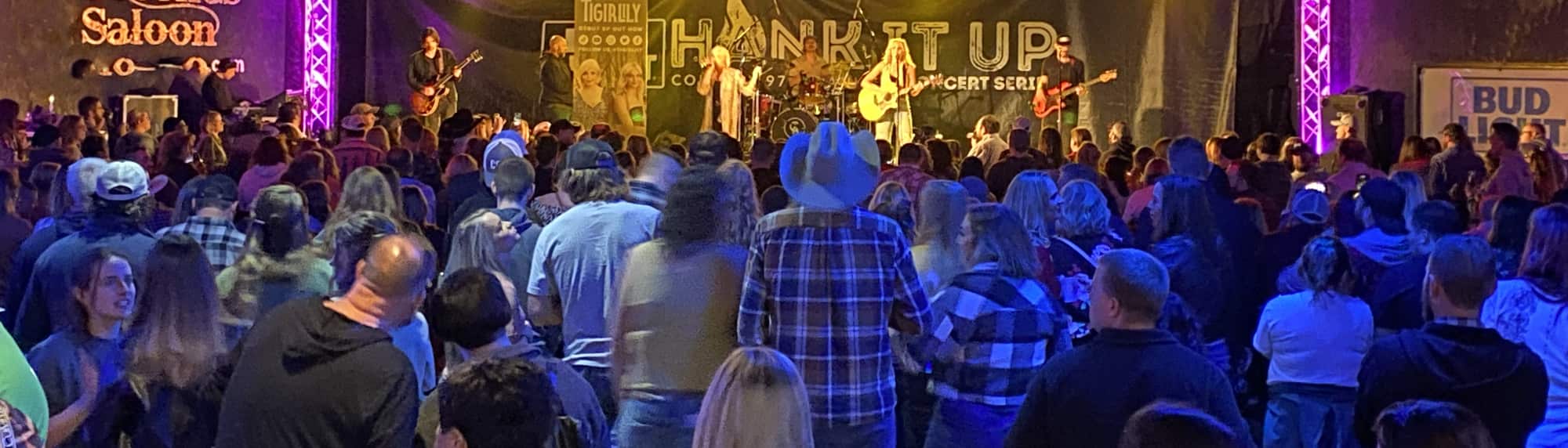country concert with fans wearing cowboy hats Boise