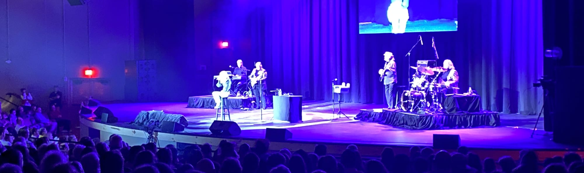 signer on stage in chair washed out by the lights Boise